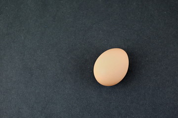 One fresh Egg, on a black background. Isolated.