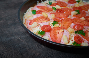 Pizza and different ingredients in it. Dark background. View from above. Studio photography, Subject photography.