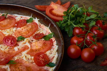 Pizza and different ingredients in it. Dark background. View from above. Studio photography, Subject photography.
