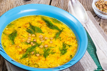 Vegetable soup puree with lentils, herbs on the background of ol