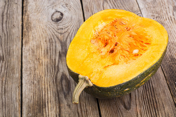 Half a butternut squash on the wooden background