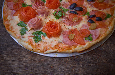 Pizza and different ingredients in it. Dark background. View from above. Studio photography, Subject photography.