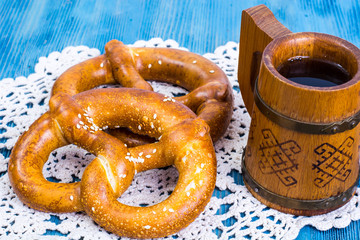 Freshly baked pretzels with salt and cheese on a blue background
