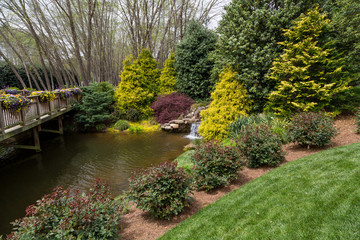 Small Waterfall into Pond by Bridge