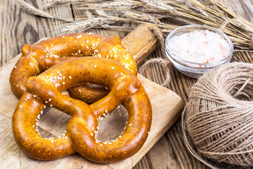 Fresh salty German bread: pretzels on a background of old boards