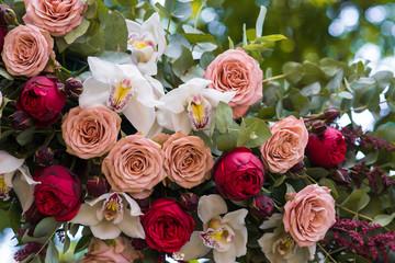 Beautiful wedding ceremony outdoors. Decorated chairs stand on t