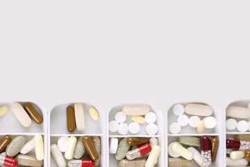 Medicine dose box. Prescription pills and vitamins in a pill box.Isolated.