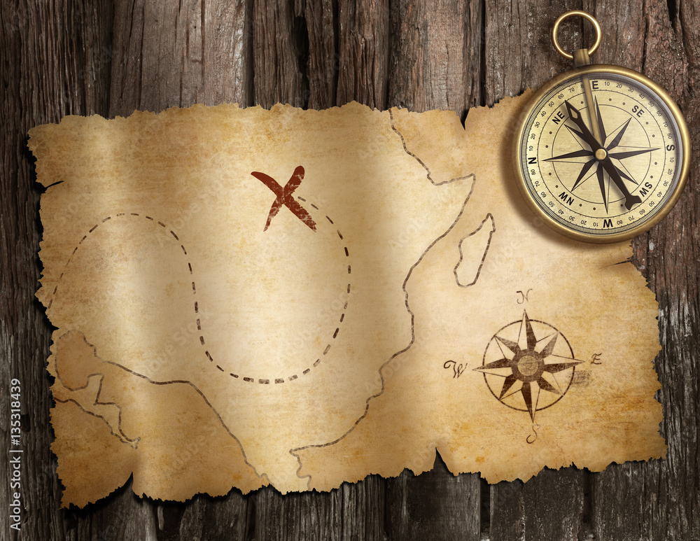 Poster old nautical compass on wood table with treasure map