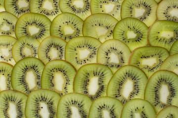 Bright green background with slices of juicy kiwi. Healthy food