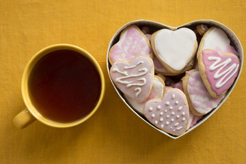 Сup of tea and cookies with frosting in shape of heart. Valenti
