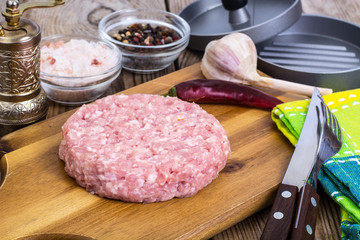 Minced meat for cooking hamburger on wooden board