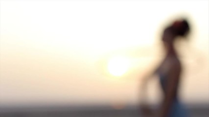 Active joyful woman at the beach playing with hula hoop at sunrise in fashion dress. Authentic creative shot. Copyspace text. - Powered by Adobe