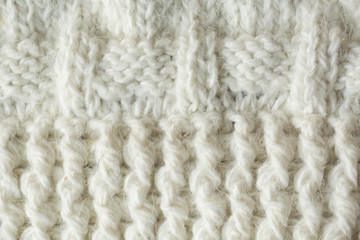 Knit texture of white wool knitted fabric with cable pattern as