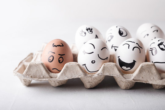 Eggs with funny faces in the package on a white background. Easter Concept Photo. Eggs. Faces on the eggs Eggs