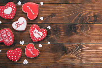 Heart-shaped biscuits for Valentine's Day. Gingerbread Valentine on wooden background. Free space for your text