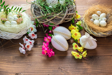 Fototapeta na wymiar Beautiful Easter eggs with flowers on the wooden background