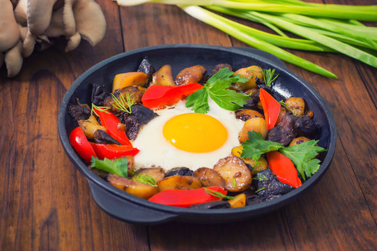 baked potato with mushrooms and egg. Wooden background. Top view