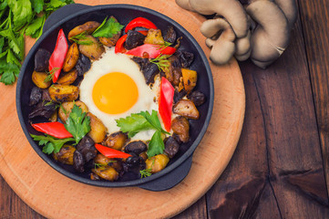 baked potato with mushrooms and egg. Wooden background. Top view