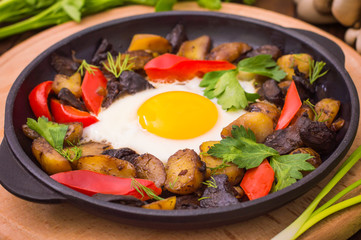 baked potato with mushrooms and egg. Wooden background. Top view