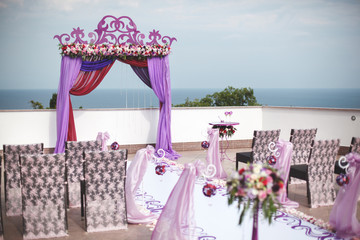 Arch lilac color for a wedding ceremony at sea. Mountain.