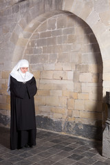 Young nun in old church
