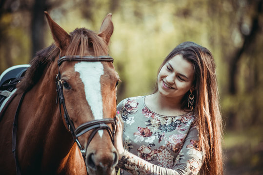 Young girl with a horse in the forest.