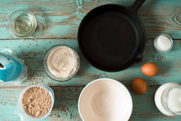 Obraz na płótnie Canvas Ingredients for pancakes gluten free on the blue wooden table horizontal
