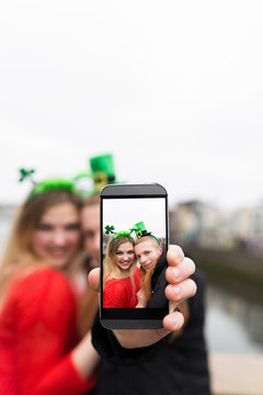 Young Couple Taking a Photo with a Mobile Phone for St Patrick D