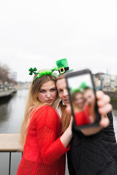 Young Couple Taking a Photo with a Mobile Phone for St Patrick D