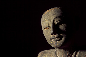 Traditional Aged Carving of a Buddhist Monk