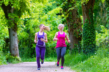 Obraz na płótnie Canvas Women doing sport jogging in park