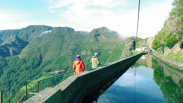 Tourists Walking on Hiking Pathway Levada Waterway