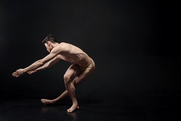 Fototapeta na wymiar Artistic ballet dancer performing in the studio