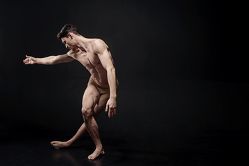 Fototapeta na wymiar Flexile ballet dancer performing in the studio