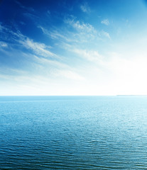 Fototapeta premium perfect sunset in blue sky over sea. aerial view