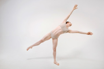 Obraz premium Graceful young ballet dancer stretching in the studio