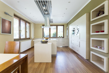 Spacious kitchen with white furniture