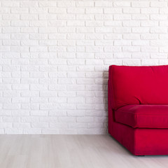 Red sofa in simple white interior