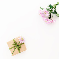 Gift box and flowers on white background. Flat lay, top view. Valentines Day background.