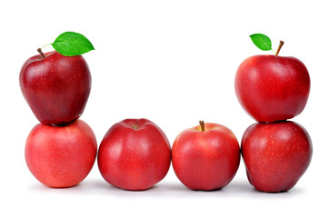 Red apples with green leaf isolated on white background.