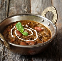 Dal Makhani / Black lentil and Red Kidney beans curry served in a Kadai, selective focus