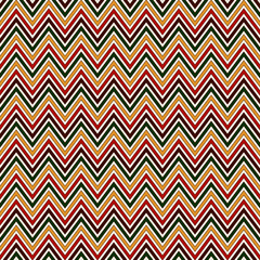 Seamless pattern in Christmas traditional colors. Chevron bright colors diagonal lines abstract background.