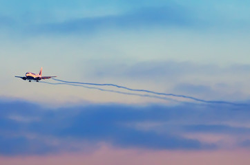 Airplane in the sky sunset