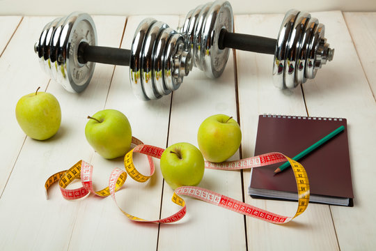 diet plan, menu or program, weight loss, measuring tape, dumbbells and dietary food fresh fruit