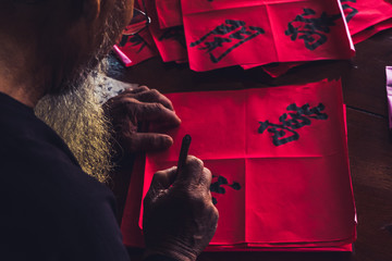 Vietnamese Calligraphy: Old Scholars are writing Calligraphy on Lunar December 21th at the Big House, an acient-style architecture with brick and wood at Long Son, VungTau City, Vietnam.