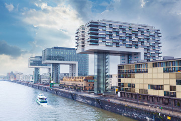 Modern business center on blue sky background in Cologne, Germany. Cologne Kranhaus - modern complex of buildings on the bank of Rhine with beautiful panoramic views in blue tones. - obrazy, fototapety, plakaty