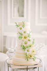 tiered wedding cake with flowers blossoming flowers.