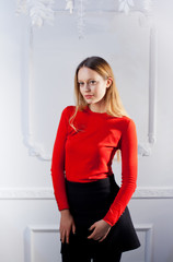 Young woman in red blouse next to brick wall Stylish fashion mod
