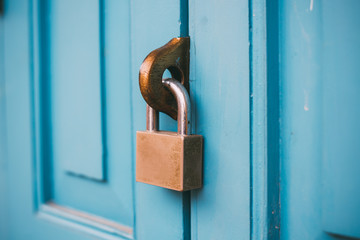 Closed vintage lock on wooden door.