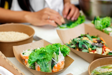 Obraz na płótnie Canvas Street vendor's salads, closeup of snacks in craft package